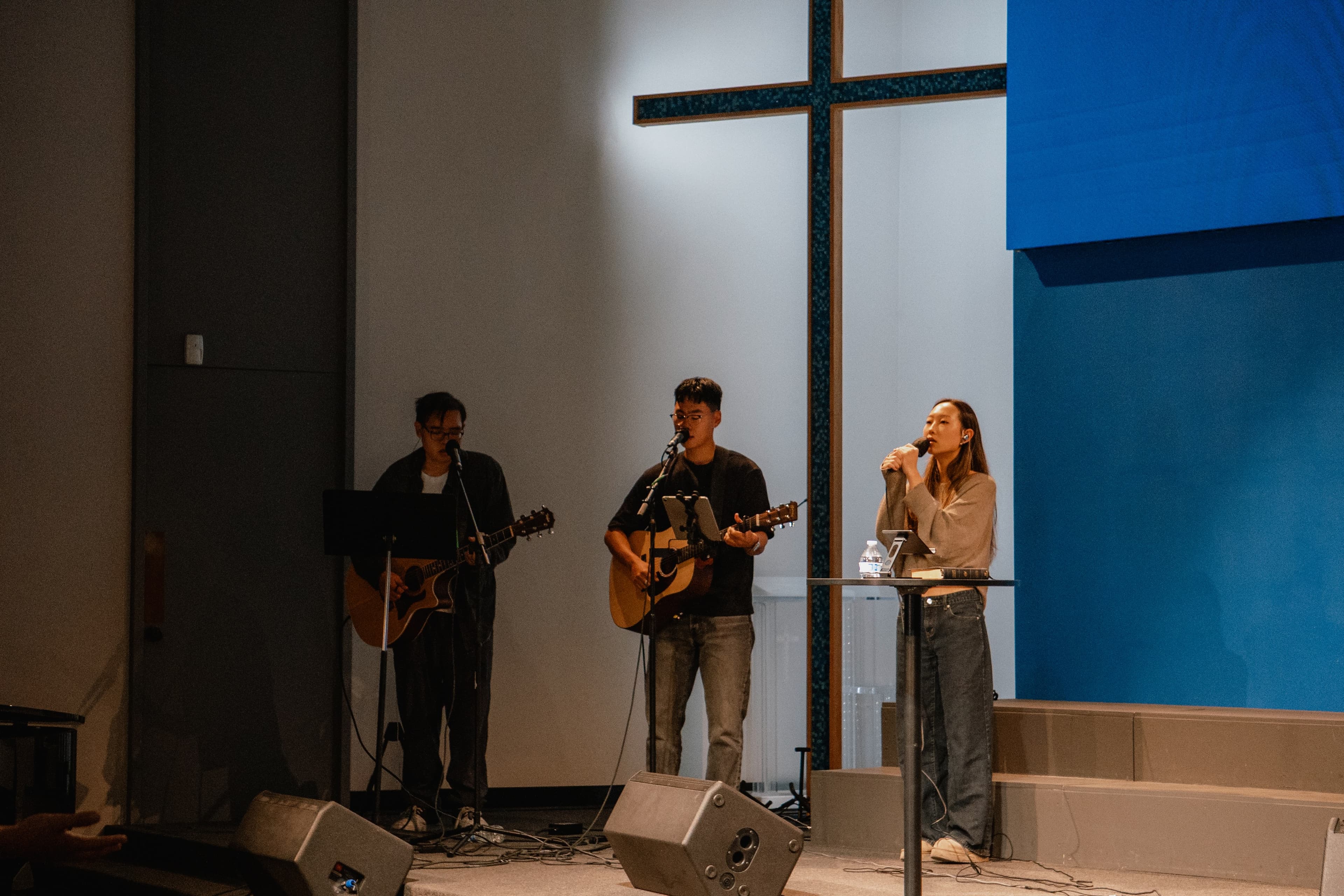 1128 worship team leading Sunday worship beneath the cross