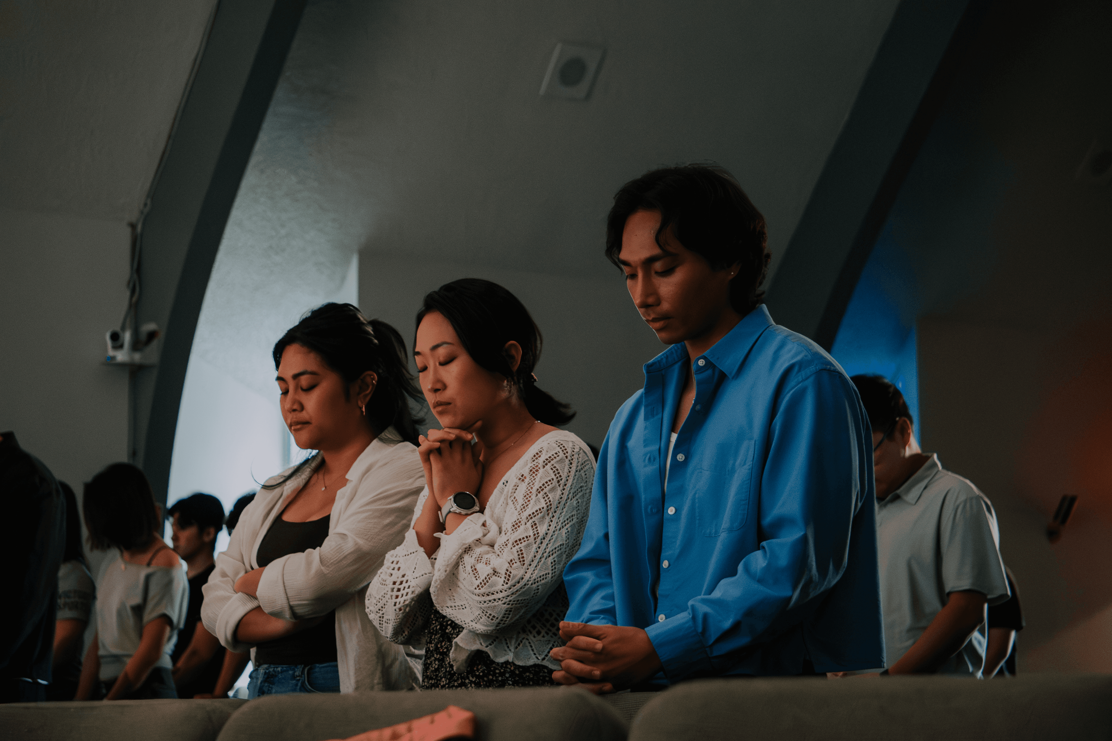 1128 community standing together in prayer